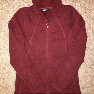 North Face red zip up jacket.